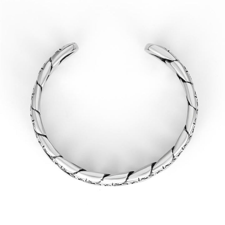 Silbernes Armband mit geflochtenen Elementen auf weißem Hintergrund.