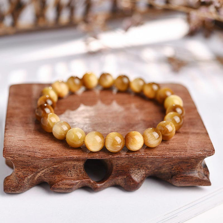 Armband Tigerauge Kristall auf Holzständer, goldbraune Perlen Heilung