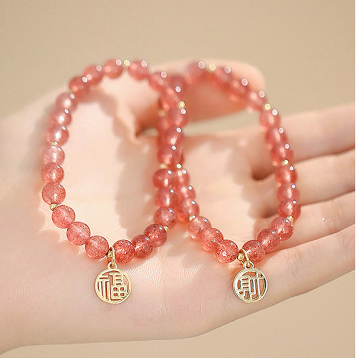 Armband Erdbeerquarz Fu-Zeichen elastisch Naturstein Perlen Goldanhänger