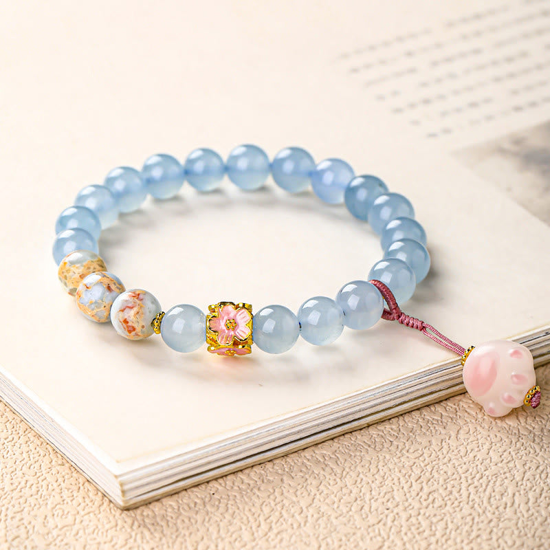 Armband Chalcedon Fu-Zeichen Heilung hellblaue Perlen Blüte rosa Anhänger Buch