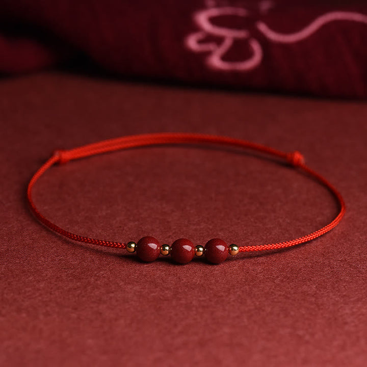 Rotes Armband Zinnober – Glück & Segen mit Perlen auf Stoff