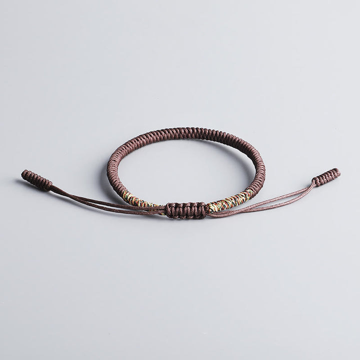 Tibetisches Armband mit braunem Geflecht und Glücksknotenverschluss elastisch