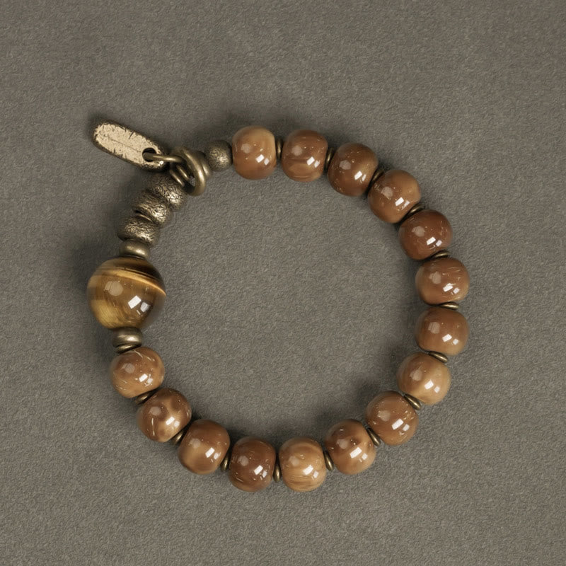 Armband Tigerauge Obsidian mit bronzefarbenen Perlen und Metallakzenten.