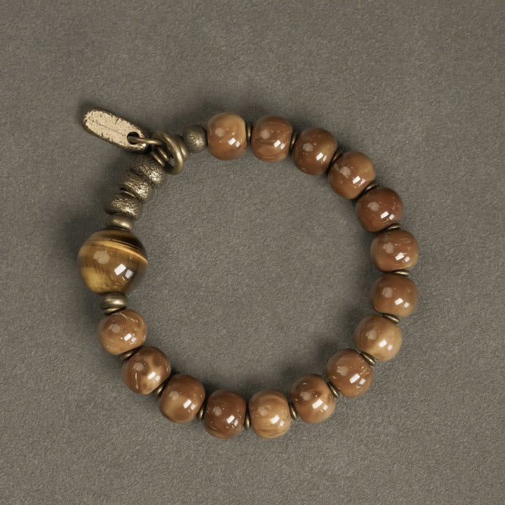 Armband Tigerauge Obsidian mit bronzefarbenen Perlen und Metallakzenten.