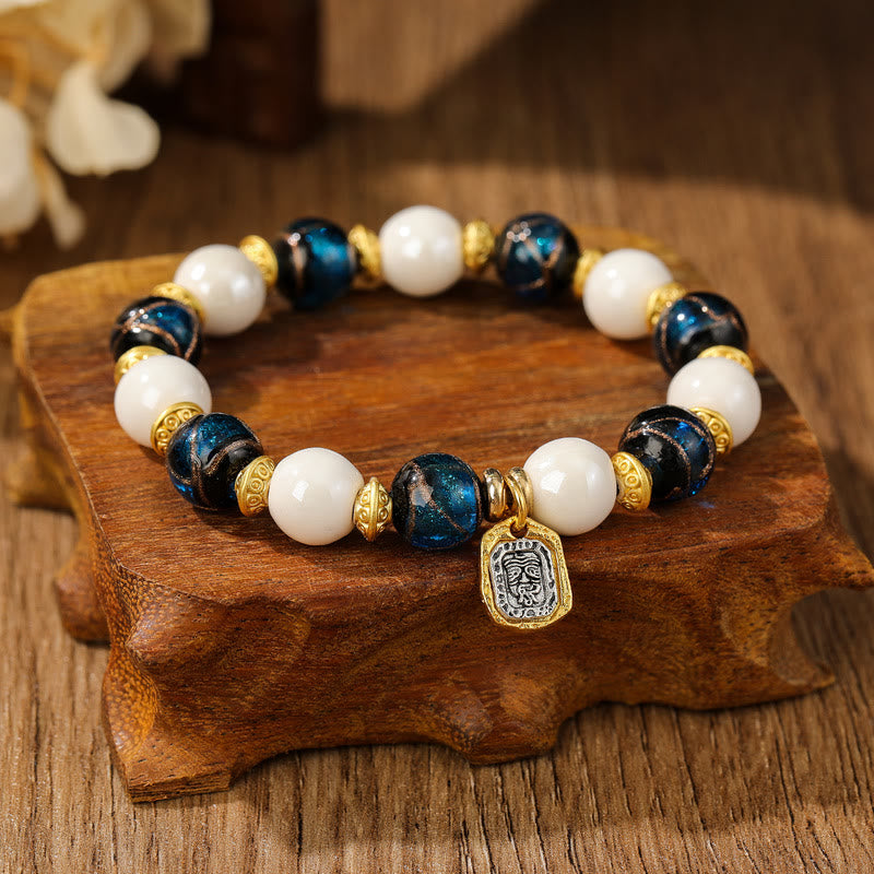 Armband – Schutz & Wohlstand & Balance mit weißen Perlen und blauem Stein