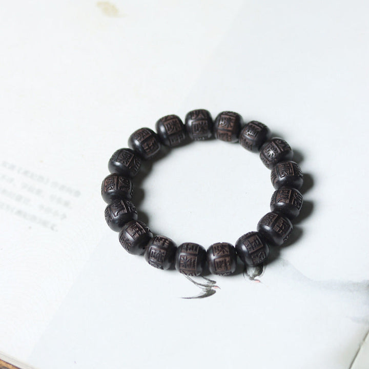 Ebenholz Armband mit Om Mani Padme Hum Gravur, elastisch getragen