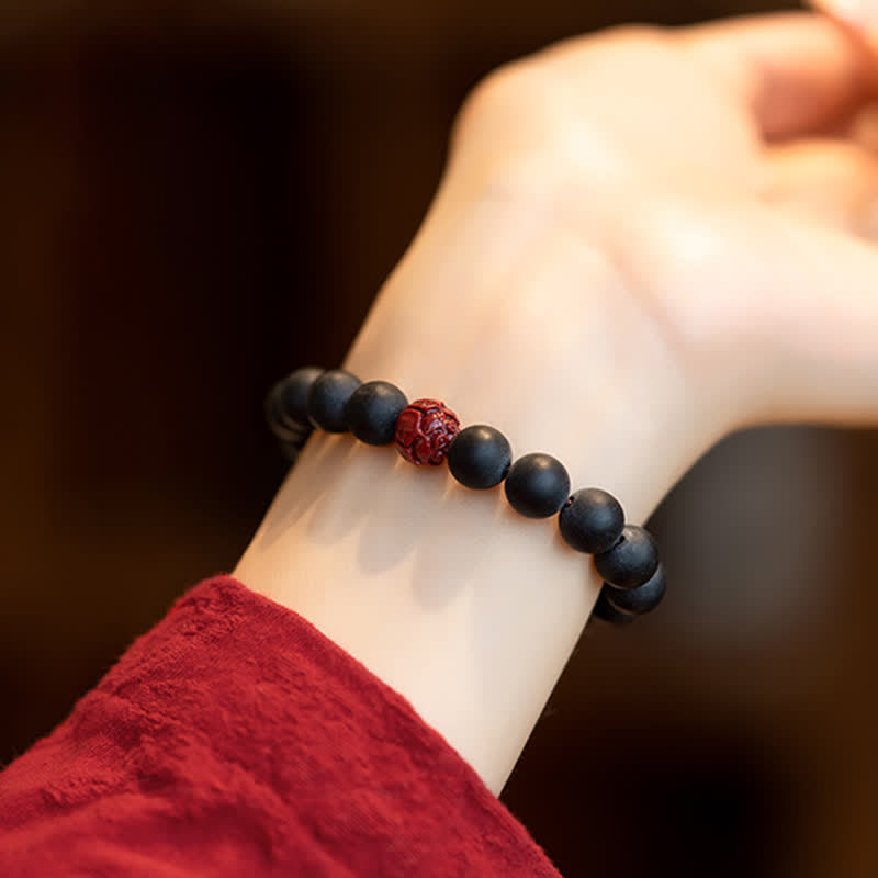 Armband Zinnober Lotus – Heilung schwarze Perlen elastisch getragen