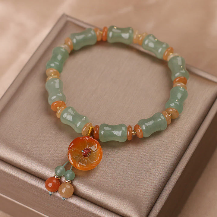Armband Jade Bambus – Glück mit grünen Steinen und orangefarbenem Anhänger