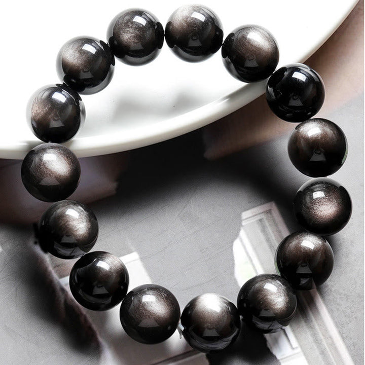 Obsidian Armband Silber Schutz schwarze glänzende Kugeln Handgelenk getragen