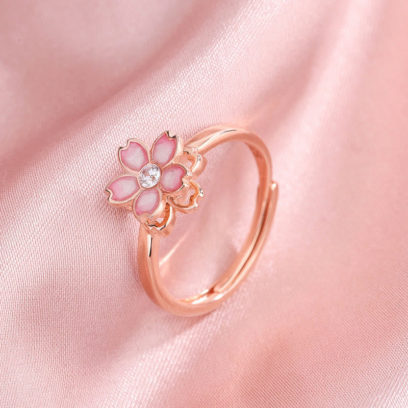 Roségoldener Ring mit rosa Blüte und Kristall Zentrum