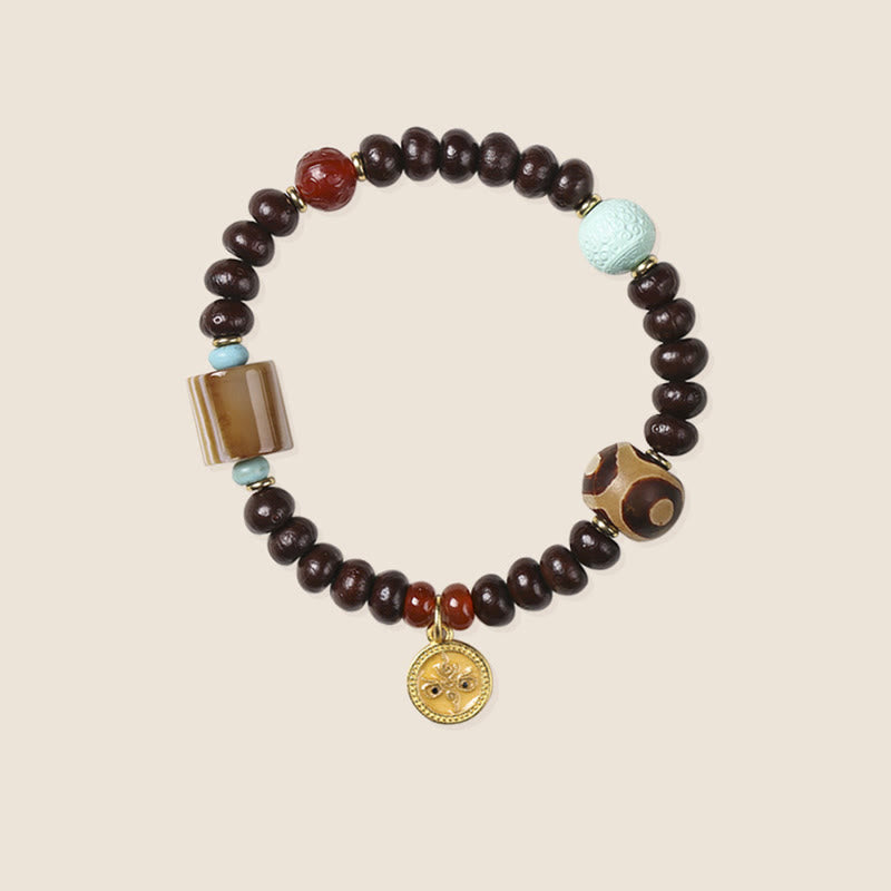 Bodhi Armband mit braunen Perlen, türkisen Akzenten und goldenem Anhänger
