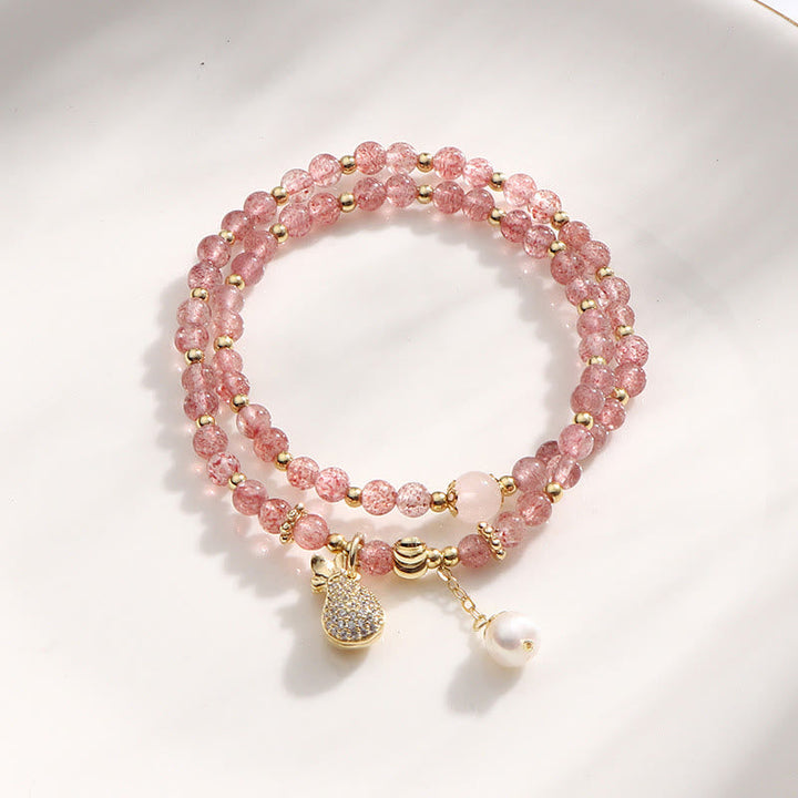 Armband Erdbeerquarz rosa Perlen goldene Akzente eleganter Schmuck
