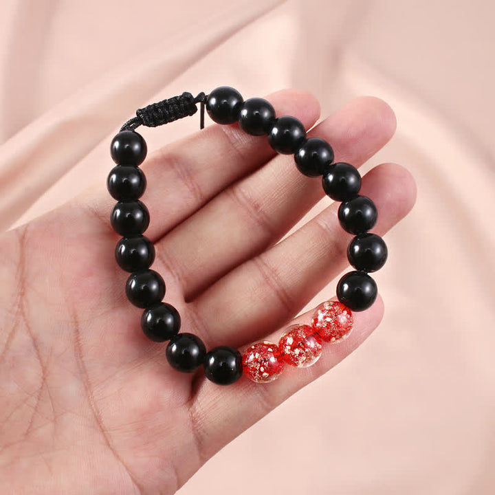 Armband Schwarzer Obsidian – Stärke mit roten Kristallperlen elegant.
