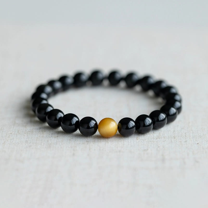 Schwarzes Obsidian Armband mit goldenem Tigerauge Perle elastisch