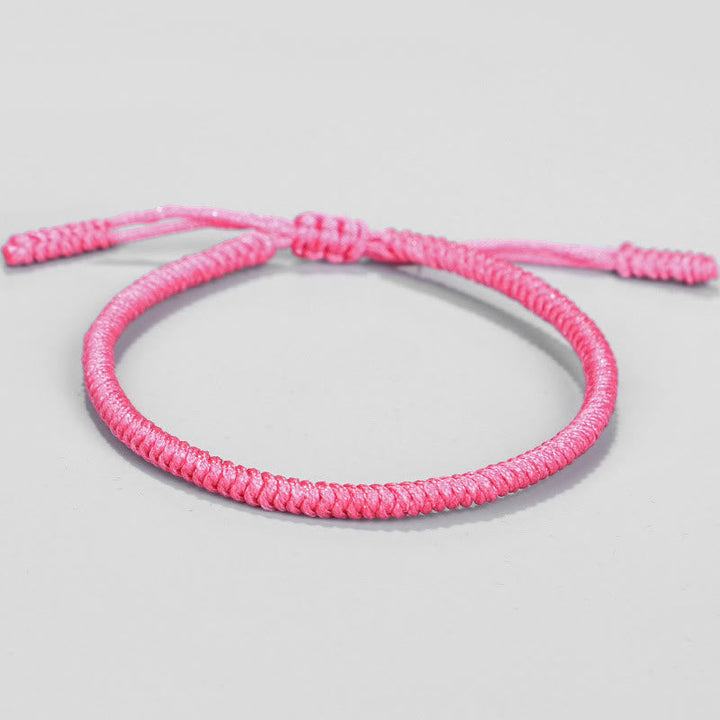 Pinkes geflochtenes Armband Tibet Knoten Schutz elastisch verstellbar.