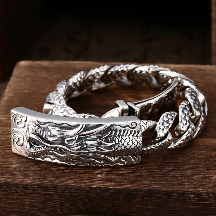 Silbernes Drachen Armband mit detaillierter Gravur auf Holz