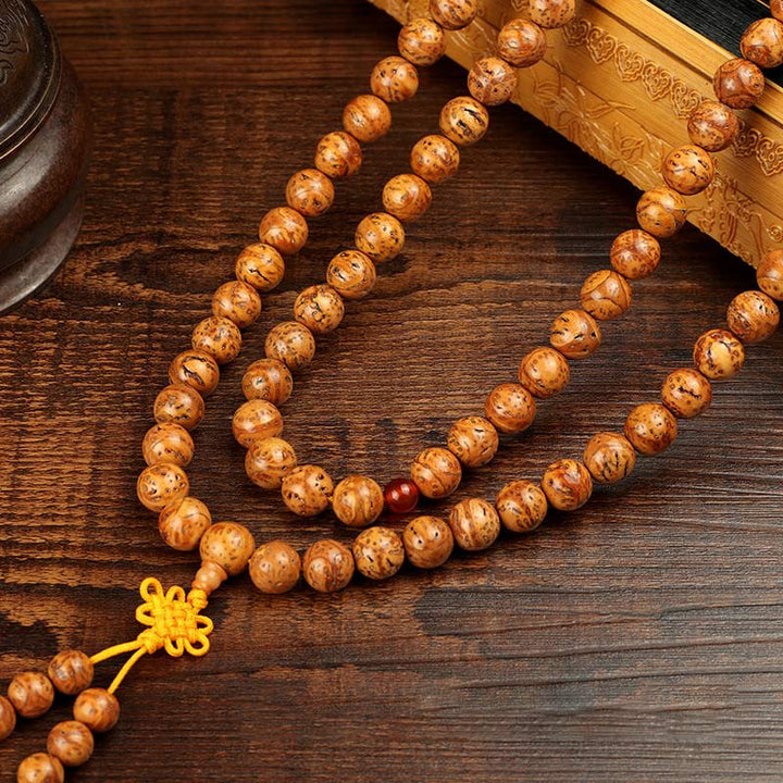Tibetisches Bodhi Samen Armband auf Holz, braune Perlen, gelbe Quaste, Weisheit