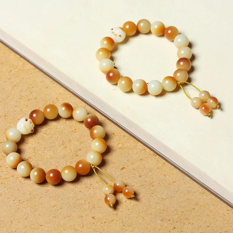 Bodhi Armband Liebe Frieden Perlen creme orange Quaste elegant