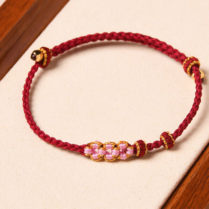 Rotes Armband Pfirsichblüte – Schutz mit rosa Steinen elastisch tragbar