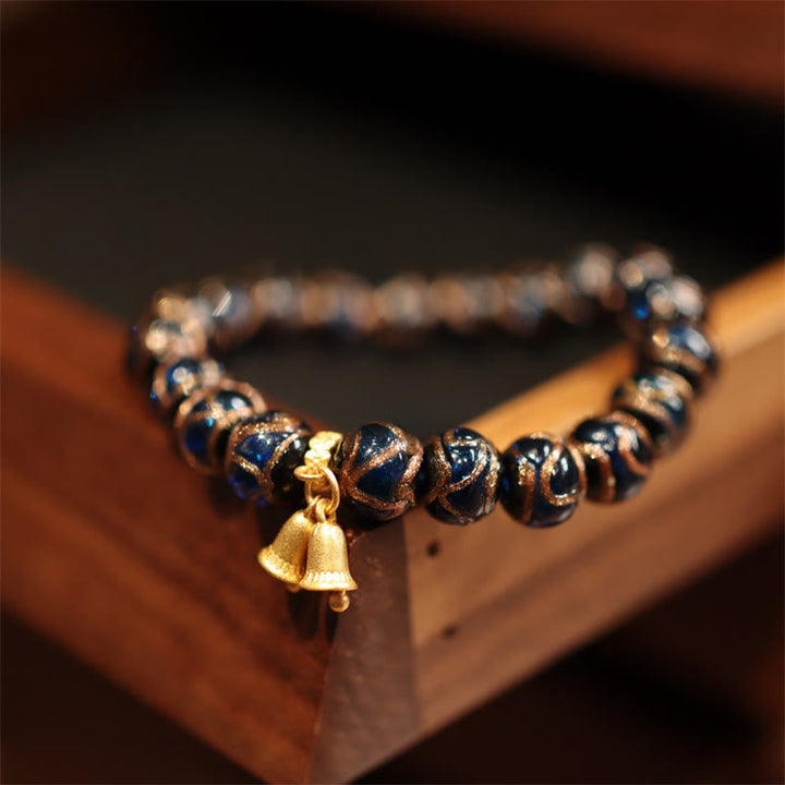 Armband – Wohlstand & Glück mit Glocke und blauen Perlen elastisch