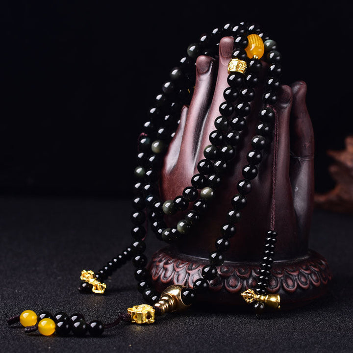 Armband Schwarzer Obsidian Lotus mit goldenen Perlen elegantes Design.