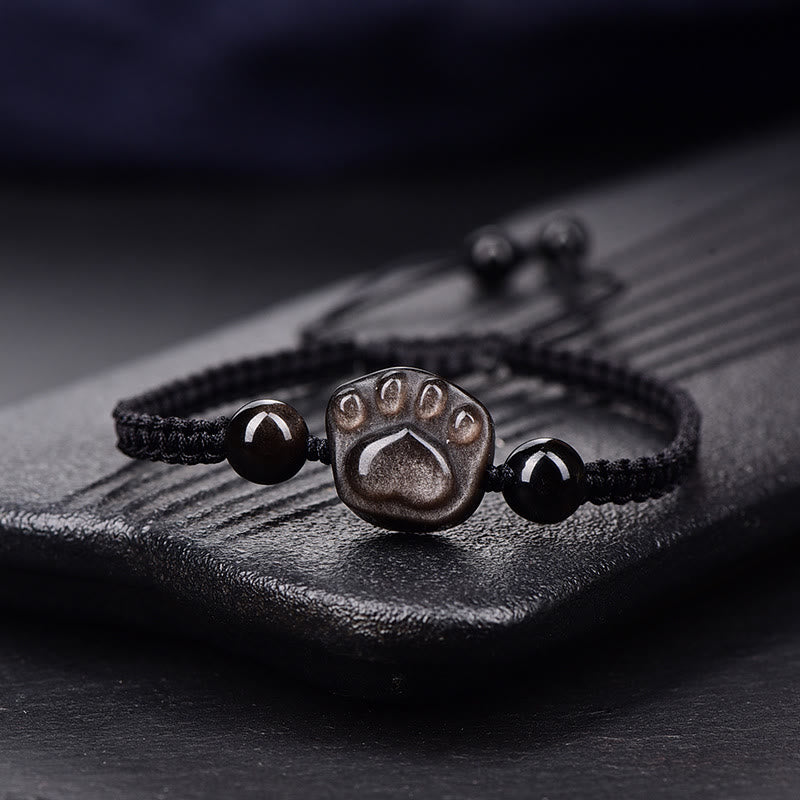 Schwarzes Armband mit Pfotensymbol und Obsidian Steinen elegant.