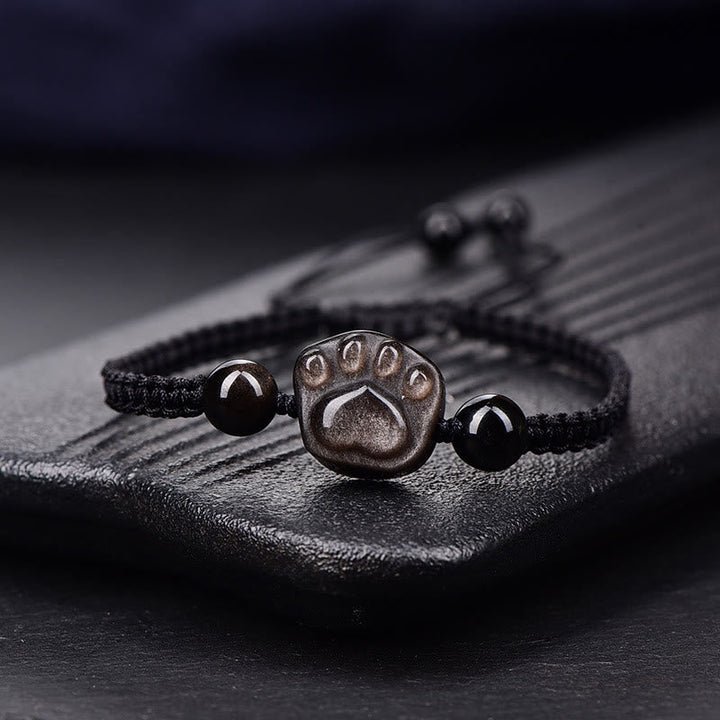 Schwarzes Armband mit Pfotensymbol und Obsidian Steinen elegant.