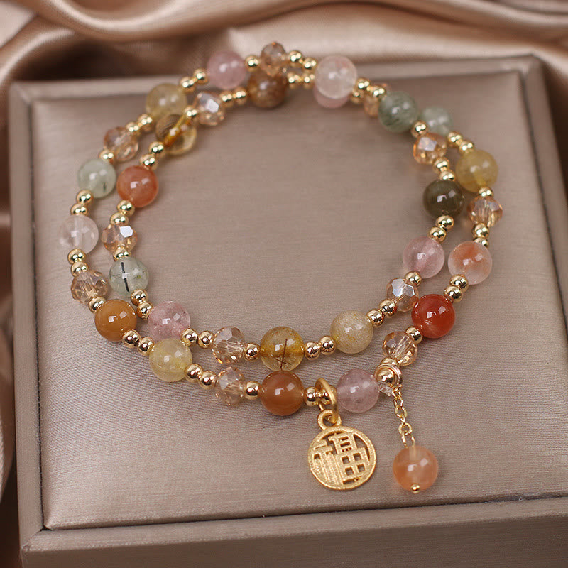 Armband Fu-Zeichen mit Natursteinen und goldfarbenen Perlen elegant.