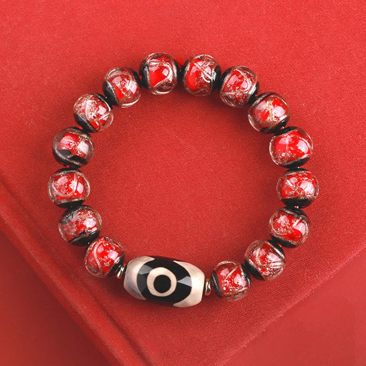 Armband – Wohlstand Balance rotes Perlenarmband mit schwarzweißem Auge Stein