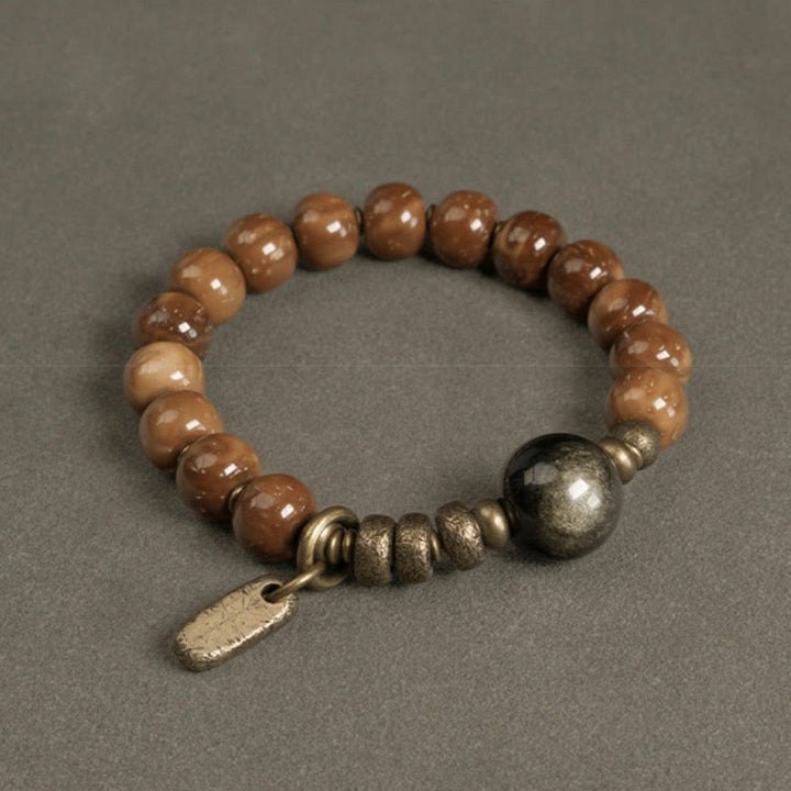 Armband Tigerauge Obsidian mit bronzefarbenen Perlen und Metallverzierungen.