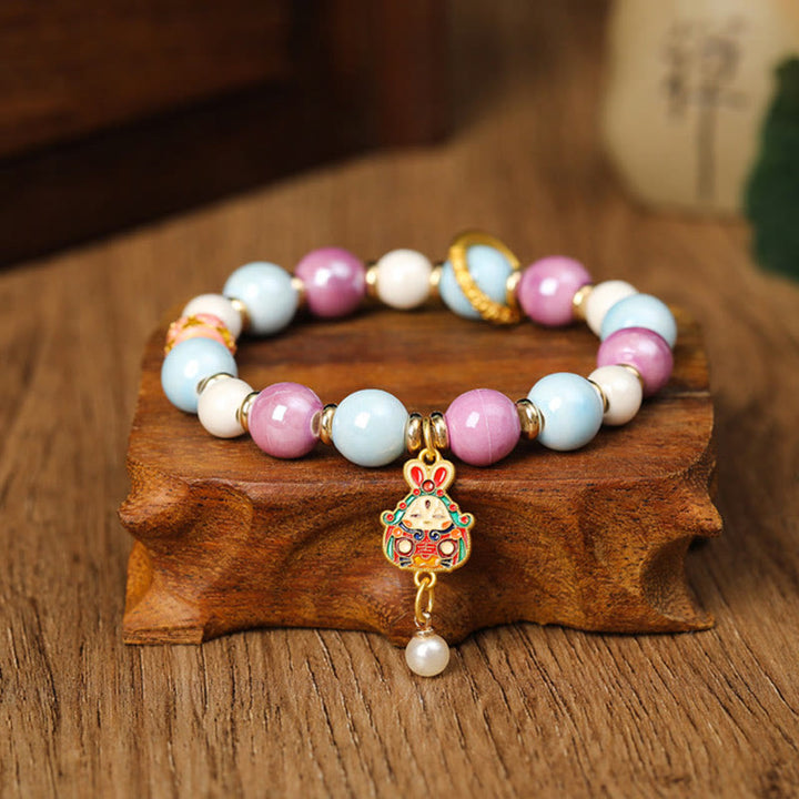 Armband – Schutz & Wohlstand & Energie mit rosa weißen Perlen Charm.