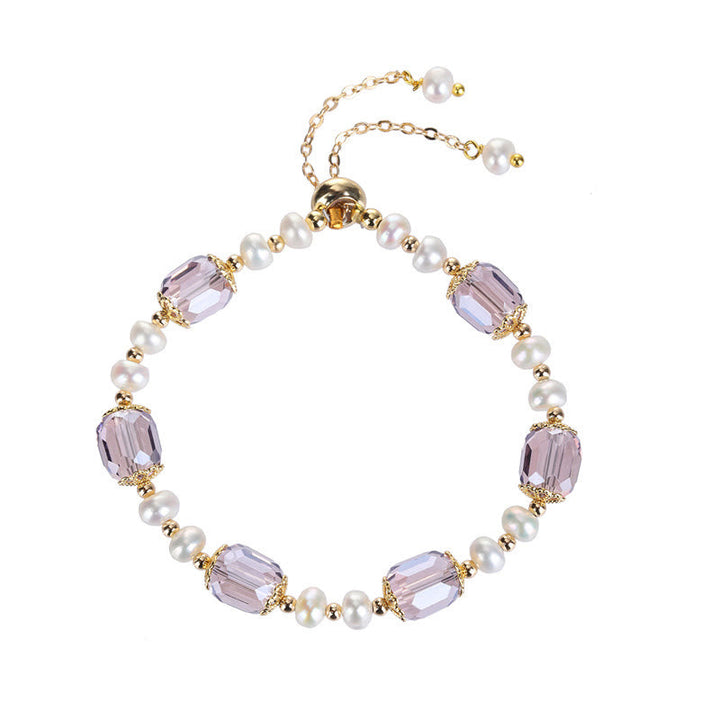 Armband Amethyst Perle mit lila Steinen und weißen Perlen golden.