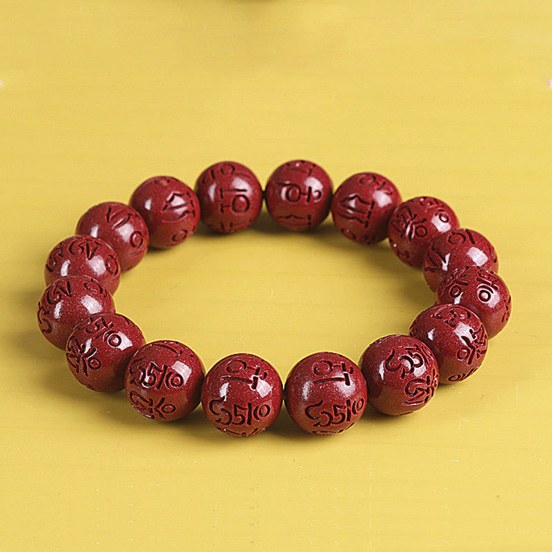 Zinnober Armband mit Om Mani Padme Hum Symbolen auf gelbem Hintergrund