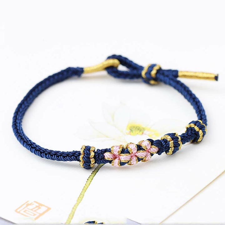 Armband Pfirsichblüte – Glück dunkelblau mit rosafarbenen Perlen