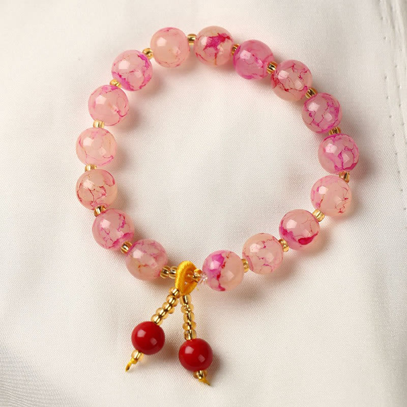 Armband – Harmonie & Segen rosa Perlen goldene Akzente rote Anhänger