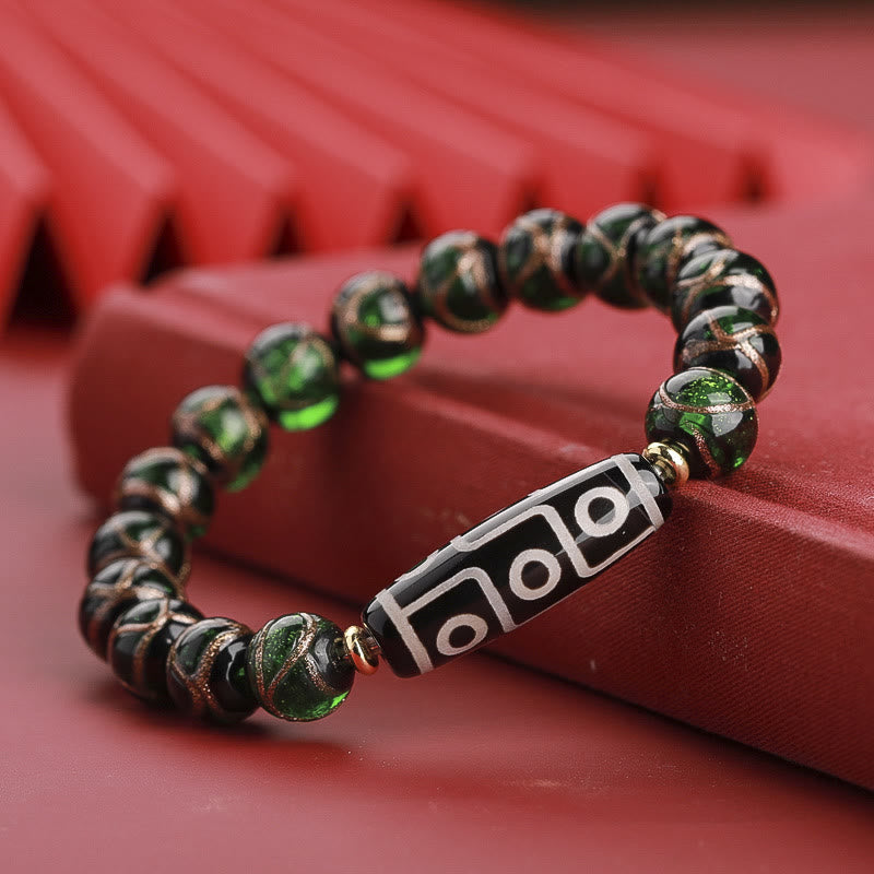 Armband – Wohlstand Balance mit grünen Steinen und schwarzen Perlen elegant.