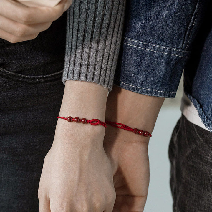 Armband Zinnober – Segen & Ruhe rote Perlen geflochten Handgelenk Paar