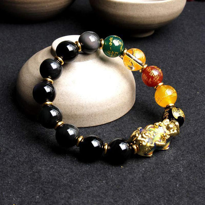 Armband Obsidian Pixiu schwarze Perlen goldene Akzente Wohlstand Energie.