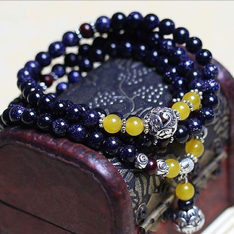 Mala – Wohlstand Armband mit dunkelblauem Stein und gelben Perlen elegant.