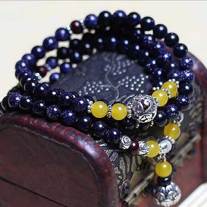 Mala – Wohlstand Armband mit dunkelblauem Stein und gelben Perlen elegant.