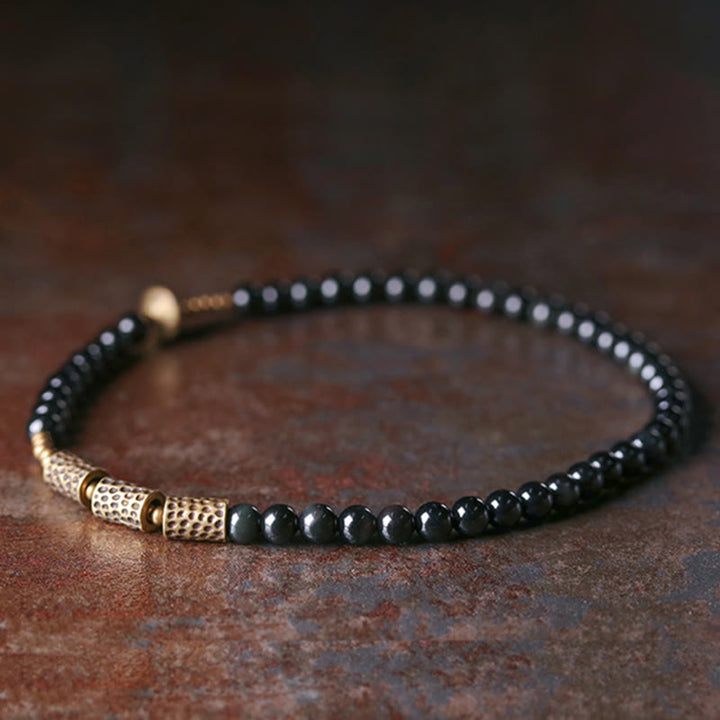 Armband Obsidian Kupfer – Liebe schwarze Perlen goldene Akzente elegant