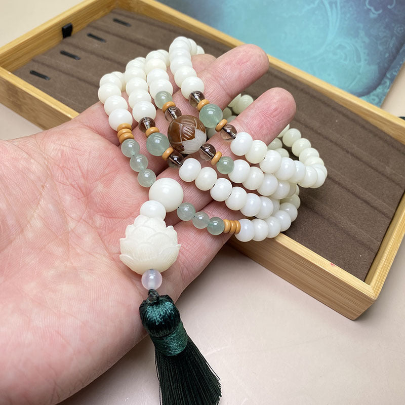 Weiße Jade Mala Malachit Armband auf Hand mit Quaste getragen