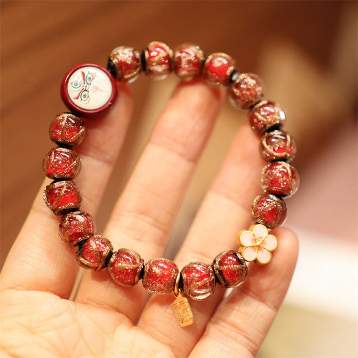 Armband – Wohlstand & Glück rotes Perlenarmband mit Glücksbringern Handgelenk.