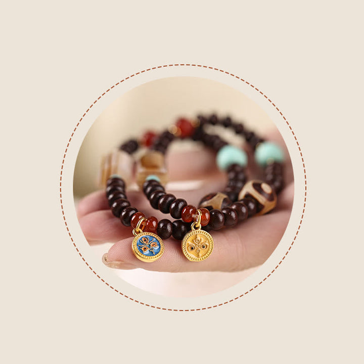Armband Bodhi Wohlstand Energie braune Perlen goldene Anhänger Handgelenk