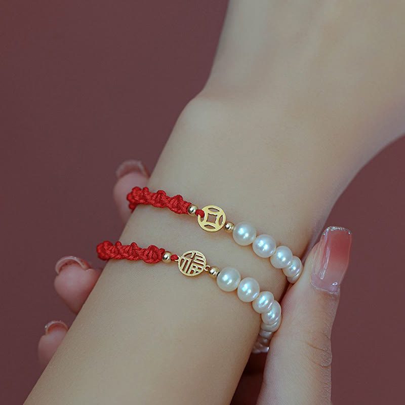 Rotes Armband Perle – Schutz & Glück mit goldenen Charms elegant getragen