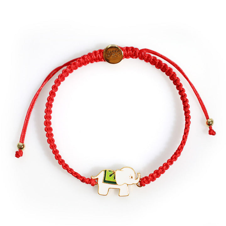 Rotes Armband mit goldenem Elefant Charm elastisch verstellbar.