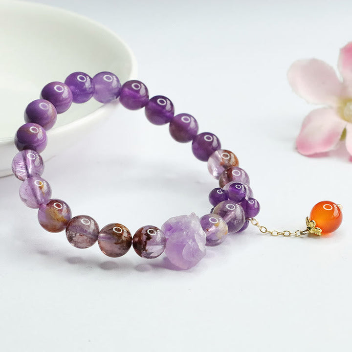 Armband Amethyst Lila Phantom Edelstein mit orangem Achat Anhänger elastisch.