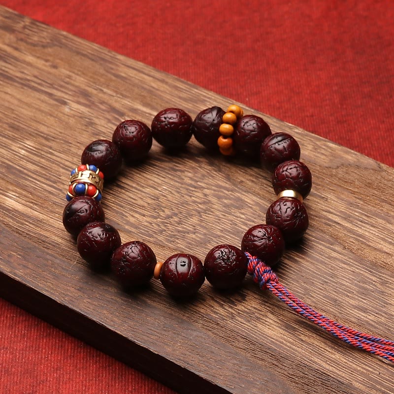 Bodhi Armband mit dunkelbraunen Perlen und orangefarbenen Akzenten.