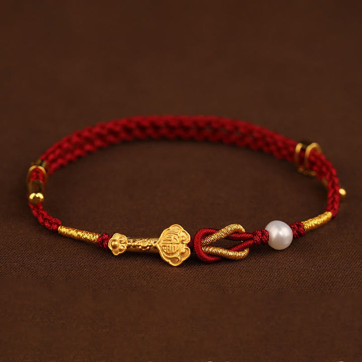 Rotes Armband Perle Fu-Zeichen Glück goldene Akzente traditionell elegant