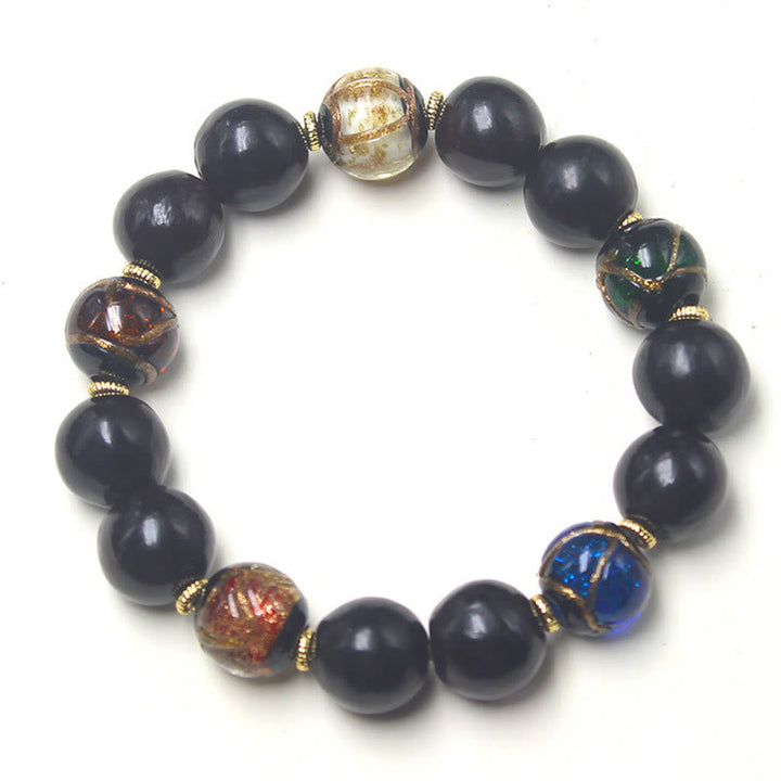 Armband – Wohlstand Harmonie schwarze Perlen goldene Spacer Naturstein elastisch